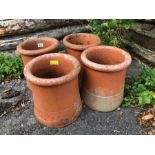 Collection of four matching chimney pots each approx 30cm tall