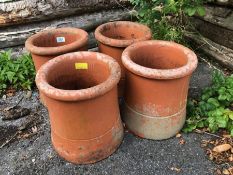 Collection of four matching chimney pots each approx 30cm tall