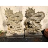 Pair of Garden statues depicting Chinese dragons on Plinths made of resin approx 89 x 54cm