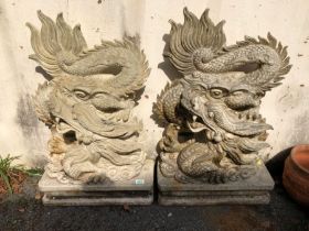 Pair of Garden statues depicting Chinese dragons on Plinths made of resin approx 89 x 54cm