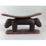 African Tribal neck rest, carved wooden neck rest in the shape of 2 Rhino end to end approximately