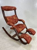 Interesting upholstered rocking chair with foot rests and adjustable headrest