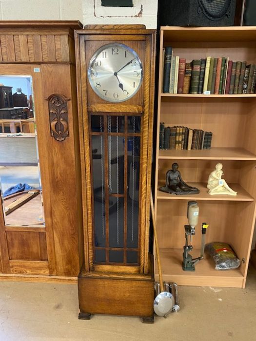 Art Deco grandfather clock with silver dial and circular aperture, with silver drop weights and