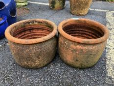 Pair of circular terracotta garden pots approx 20cm tall
