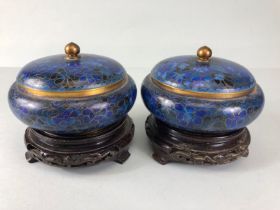 Chinese Cloisonne, a pair of Chinese Cobalt Blue Cloisonne covered dishes on wooden stands