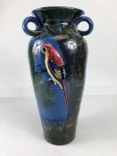 Torquay pottery, a large salt glaze pottery vase with raised and sponge design of a colourful parrot
