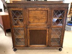 Furniture, 20th century oak bureaux display cabinet on bun feet, leaded glass display sections