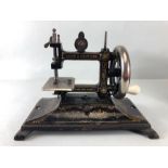 Sewing Machine, Antique child's portable sewing machine by Leigh and Crawford with cover