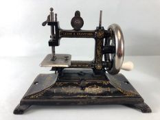 Sewing Machine, Antique child's portable sewing machine by Leigh and Crawford with cover