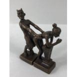 Erotica, a pair of patinated metal figures of the Devil and a woman in a sexual pose,