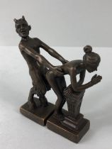 Erotica, a pair of patinated metal figures of the Devil and a woman in a sexual pose,