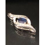 10ct White Gold Infinity pendant set with a faceted Blue Sapphire and Diamonds approx 23mm x 8.5mm