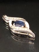 10ct White Gold Infinity pendant set with a faceted Blue Sapphire and Diamonds approx 23mm x 8.5mm