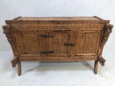 Carved Indian dowry chest on splayed legs with floral carvings and horse and princess carvings, door