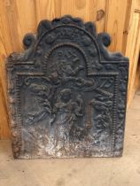 Antique wrought iron fire back depicting Eve being banished from the Garden of Eden with depiction