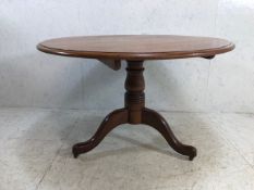 Bevel edged circular tilt topped table on tripod feet with original castors, diameter approx 114cm