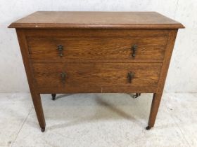 Oak chest of two drawers on tapering wooden legs with castors 92cm x 45cm x 81cm