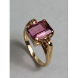 9ct Gold ring set with a faceted pink Tourmaline stone with Gold scroll shoulders size 'O'