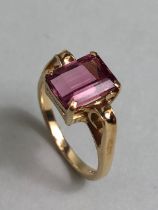 9ct Gold ring set with a faceted pink Tourmaline stone with Gold scroll shoulders size 'O'