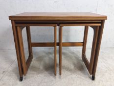 Mid Century A.H. McIntosh & Co Ltd nest of three tables with twist hinged top opening to create