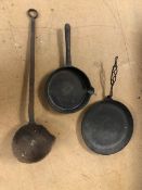Heavy metal items to include two large skillets and a large forge ladle