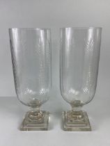 Pair of Glass storm Lanterns, with cut palm leaf design both approximately 40cm high