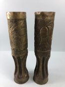 Militaria interest, WW1 trench art, a pair of tall vases decorated with embossed flowers one dated