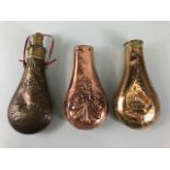 Military interest, copper and brass black powder flask with embossed decoration an 2 partial