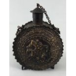 Military interest, Eastern European metal powder flask decorated with embossed geometric designs and