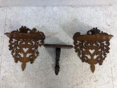 Pair of carved wooden wall sconces and one other