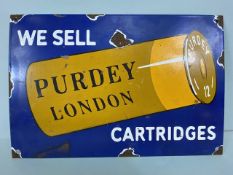 Enamel advertising sign, depicting a shotgun cartridge and "WE SELL PURDEY LONDON CARTERIDGES"