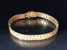 18ct Gold Bracelet in tri-coloured Gold in a gate bracelet style with double safety catches approx