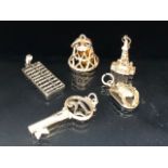 Collection of five charms to include an abacus, bell, key etc