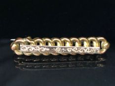 Gold coloured bar brooch stamped M&J to reverse approx 40mm in length