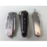 Military interest, 3 British military Utility or Jack knives, one with black checkered grips dated