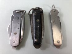 Military interest, 3 British military Utility or Jack knives, one with black checkered grips dated
