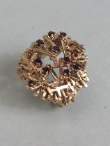 9ct gold hand crafted dandelion ring set with Garnets size approximately L and 7.81g inclusive