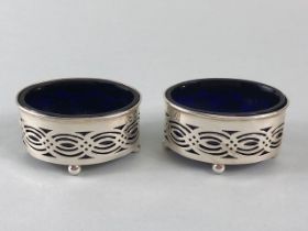 Pair of Silver salts with blue glass liners on four ball feet with pierced decoration Hallmarked for