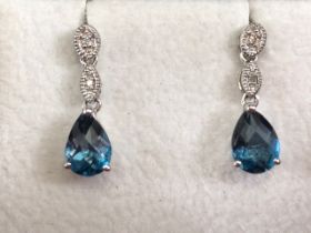 Pair of 9ct white gold set pear drop blue gemstone earrings