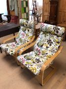 Pair of modern wooden framed easy chairs with colourful upholstered cushions