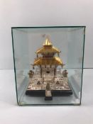 Oriental interest, model of a Thai Temple in white and yellow metal set with stones , sealed in a