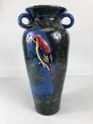 Torquay pottery, a large salt glaze pottery vase with raised and sponge design of a colourful parrot