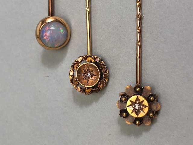 18ct Gold stick pin surmounted by an Opal with two further 15ct stick pins each set with a central - Image 2 of 3
