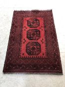 Red ground rug 100% wool with all over decoration approx 150cm x 100cm