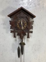 Black forest style wooden cuckoo clock with pine cone weights and pendulum