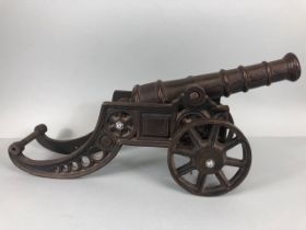 Vintage cast metal canon on scrolling carriage, barrel approximately 27cm long ,45cm overall