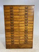 Light oak specimen cabinet with two flights of 14 narrow drawers with metal cup handles with