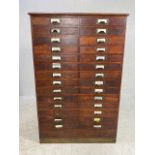 Dark stained oak specimen cabinet with two flights of 14 narrow drawers with metal cup handles