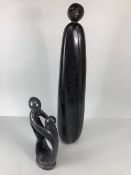 African Zimbabwean stone sculpture of a woman and child and an elongated human figure both of