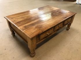 Modern light wood coffee table with three drawers to each long side, approx 120cm x 80cm x 45cm